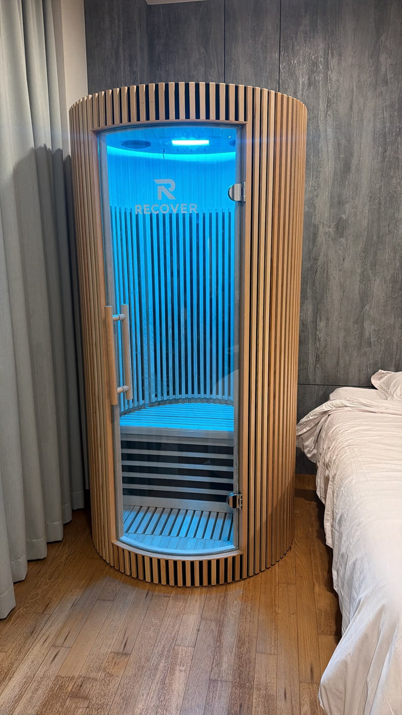 R Sauna Circle in blue light beside a bed