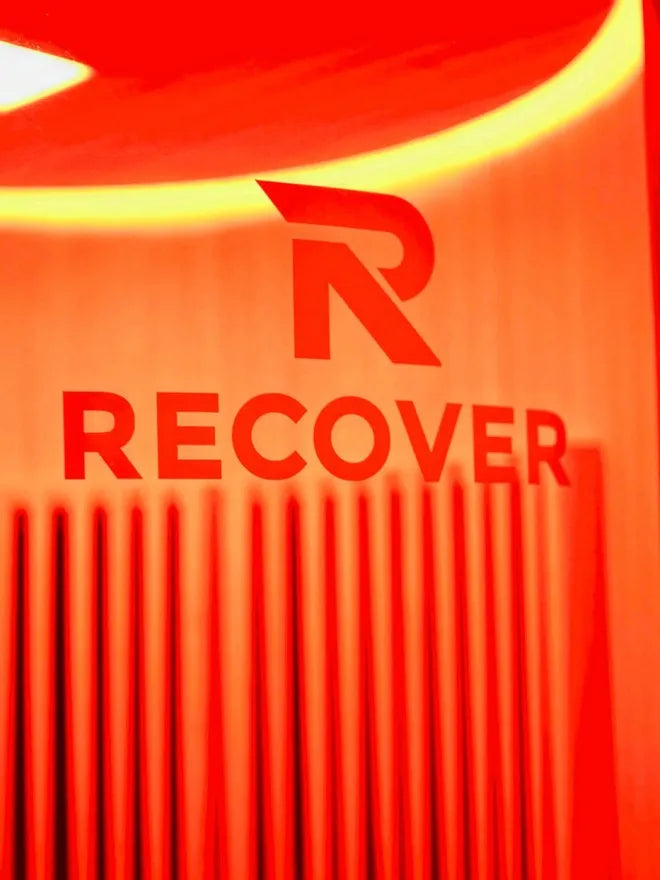 Recover branding on the warm red-lit interior wall of the R Sauna Circle far-infrared sauna